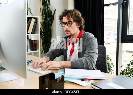 3d Man Using A Computer A man with curly hair and glasses works on a laptop next to a 3D ...