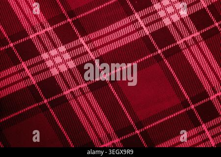 Red and dark maroon plaid fabric texture with checkered tartan pattern Stock Photo