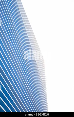 Modern building facade showcasing a repetitive pattern of blue vertical lines Stock Photo