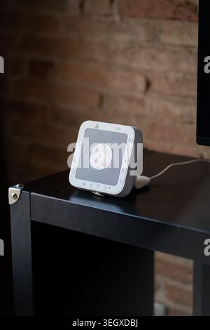 Smart home security system control panel central button with red glowing icons Stock Photo
