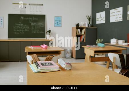 Empty Classroom Showing School Desks and Learning Materials Stock Photo