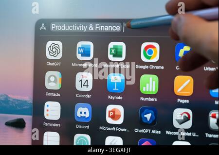 New York, USA - May 14, 2026: Selecting computer productivity and finance app on screen menu pointing with pencil  close up view Stock Photo