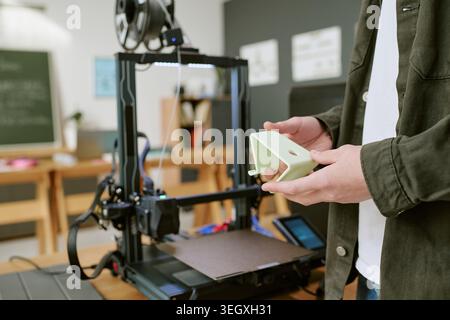 Unrecognizable Teen Boy Holding 3d Printed Prototype in Classroom Workshop Stock Photo