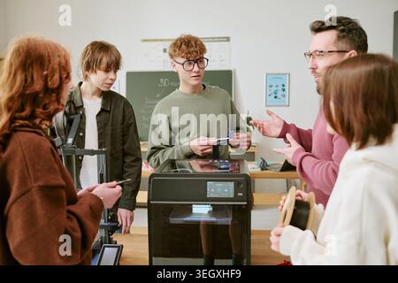 Teenagers Learning 3d Printing with Teacher in Stem Classroom Stock Photo