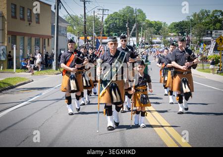 The Celtic Cross Pipe & Drum marching band with a 6 year old leading the way at the 2026 Bethell Memorial Day Parade in Connecticut, 5/17/2026. Stock Photo