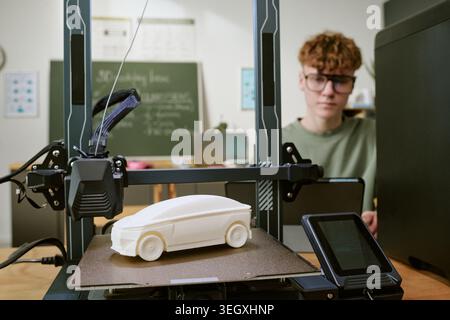 Teenager Boy Monitoring 3d Printing for Stem Learning Project Stock Photo