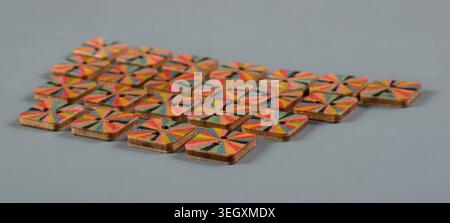 Colorful handcrafted wooden buttons arranged on gray background for sewing, textile craft and fashion accessories Stock Photo