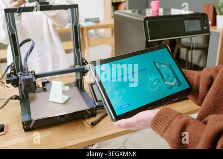 Teenager Using Tablet for 3d Printing Workflow in Classroom Stock Photo