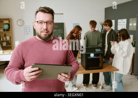 Portrait of Middle Aged Man Teaching Teenagers 3d Printing Stock Photo