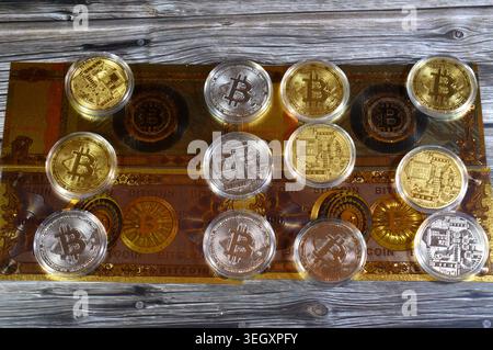Cairo, Egypt, May 14 2026: physical bitcoins, Bitcoin (BTC), on gold plated novelty 100 bitcoin BTC notes, features Vault door open on bitcoin symbol Stock Photo