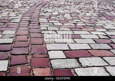 Red and grey cobblestones on an old European street. Stock Photo
