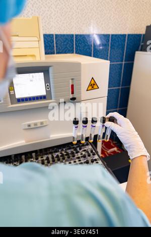 Scientist Holding Blood Test Tubes in Medical Laboratory Stock Photo