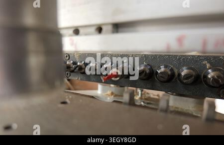 Industrial cnc machine presenting its array of drill bits ready for automated operations, indicating precision and efficiency in modern woodworking an Stock Photo