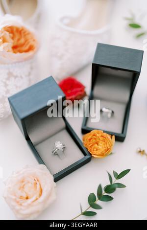 Stylish wedding ring and bouquet arrangement. Charming scene featuring engagement rings with floral accents Stock Photo