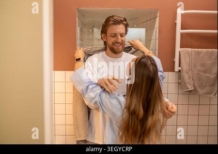 Young couple having morning procedures and having fun feeling happy and joyful Stock Photo