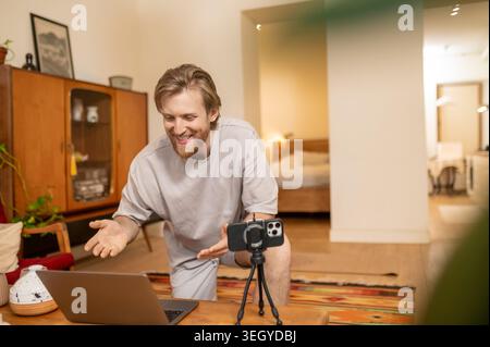Young man having online class and looking busy and involved Stock Photo