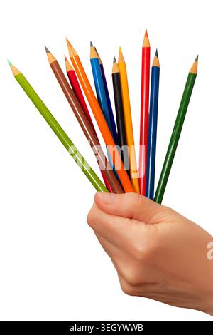 A hand holds several colored pencils in various shades, ready for use in art or craft projects. The setting indicates an active crafting session. Stock Photo