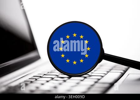 European Union symbol near laptop keyboard closeup. Digital technology and cybersecurity concept with european online communication theme. Stock Photo