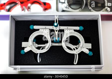 Optometry Trial Frame in Examination Box. Close-up of adjustable optometry trial frames in a case, used for eye exams, vision testing, and Stock Photo