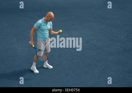 Athletic mature tennis player holding racket and ball on blue sports court during summer training. Healthy lifestyle and professional sport concept. Stock Photo