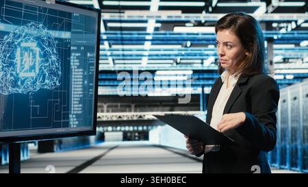 Monitoring systems, artificial intelligence tech and engineer in automated industrial data center. Using AI, machine learning and IT expert in server room overseeing network performance Stock Photo