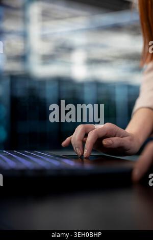 Close up of data center engineer typing on laptop keyboard, coordinating backups and recovery protocols. Server farm expert using notebook, upgrading equipment components Stock Photo