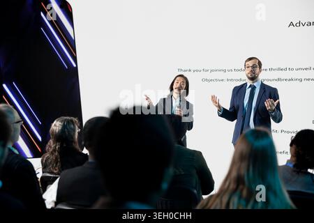 Multiethnic senior designers team revealing new smartphone launch at business conference, taking advantage of event for new release advertising. Engineers presenting product coming soon. Stock Photo