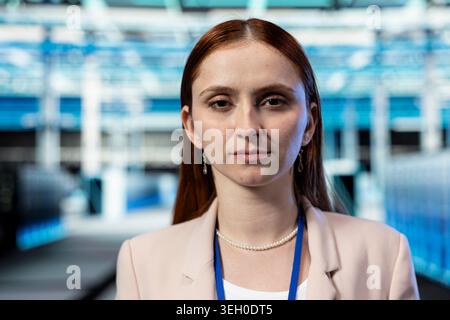 Portrait closeup of data center female programmer doing protection against network threats. Server hub cybersecurity department employee auditing systems for errors and computer bugs Stock Photo