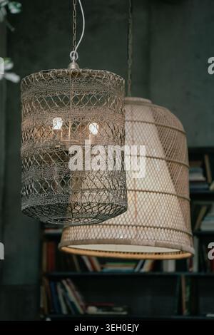 Vintage hanging lamps with warm light in a cozy rustic interior. Stock Photo