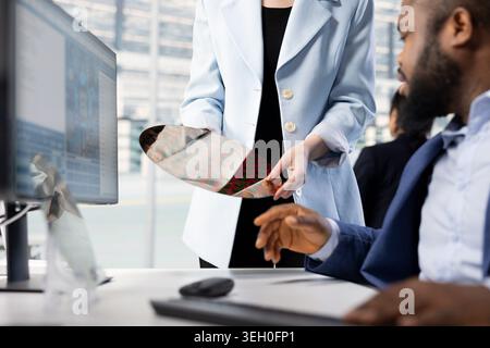 Close up of engineers holding silicon wafer, doing quality inspection in microchip factory RD lab. Specialists examining intricate circuit patterns on semiconductor substrates Stock Photo