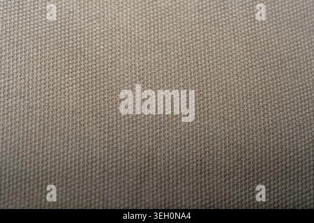 Close up of beige burlap woven fabric with natural fibers, coarse textile texture and neutral rustic background detail. Stock Photo