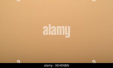 Warm beige kraft paper background with smooth surface, subtle texture and soft tonal variation for minimal natural design use. Stock Photo