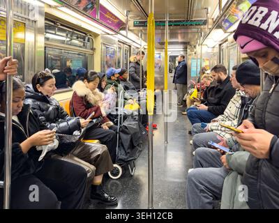 New York, United States - 14 May 2026: View of passengers sitting and standing inside a subway car, many using their smartphones while commuting throu Stock Photo