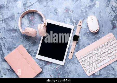 Composition with different modern gadgets and notebook on blue grunge background, closeup Stock Photo