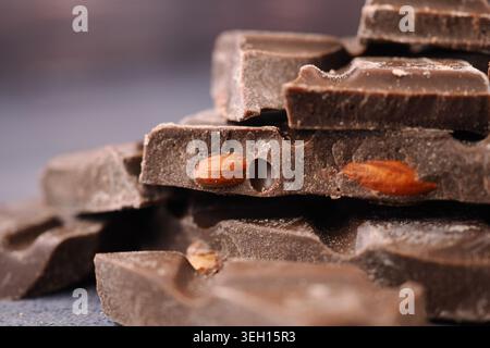 Chocolate pieces with almonds on a blue surface Stock Photo