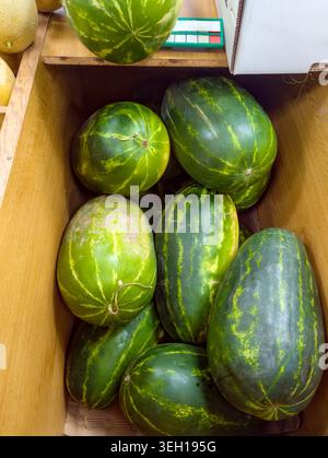 large ripe melons in a box in a supermarket on the island of Crete (Greece) Stock Photo