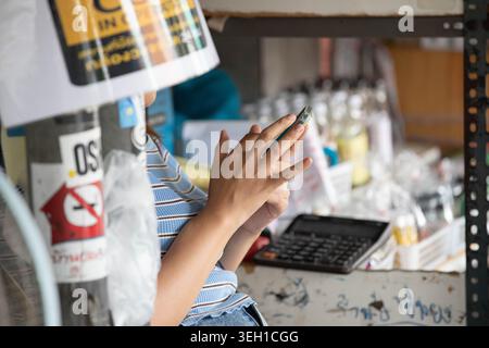 Female hands using smartphone, casual phone use outdoors, relaxed digital moment, close up Stock Photo