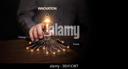 A man hand touching glowing rocket lightbulb icon on dark copyspace. Innovation, creativity, change, future technology, startup launch, business growt Stock Photo