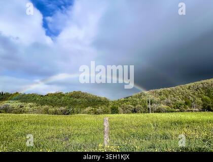 Rainbow after the storm in Mugello country, Italy Stock Photo