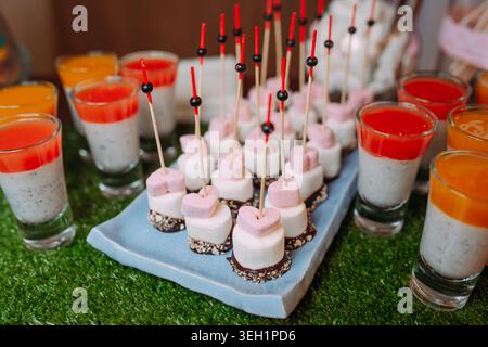 Catering table with marshmallows, canapes and jelly desserts Stock Photo