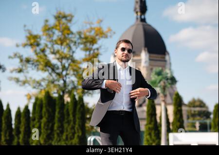 Man in Tuxedo Adjusting Jacket Stock Photo