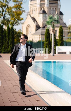 Man in Tuxedo by Pool Stock Photo