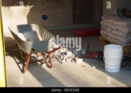 Construction work tools and debris in unfinished interior space Stock Photo