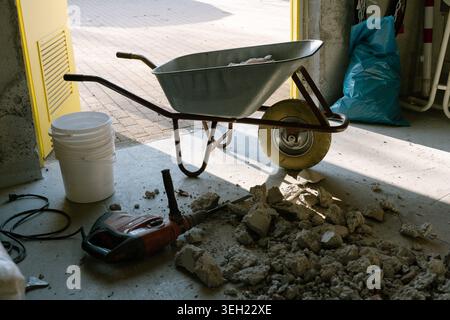 Construction work tools and debris in unfinished interior space Stock Photo