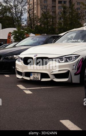 BMW Urban Display. Mattefinish BMW Vehicle With Custom Decals In City Parking Lot Under Cloudy Skies Stock Photo
