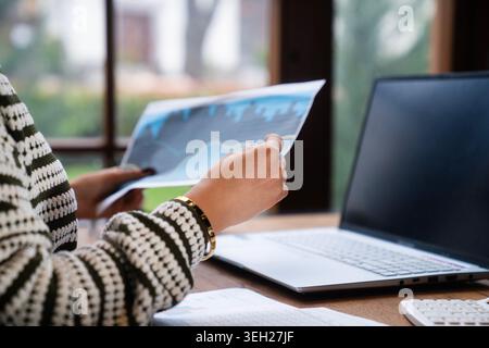 Close-up of a professional analyzing financial charts and stock market data on a digital tablet near a laptop. Perfect for investment, trading, fintec Stock Photo
