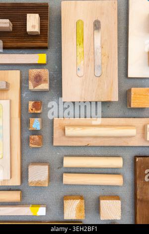 Flat lay of various wood and plywood pieces on concrete texture. Carpentry background. Stock Photo