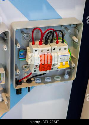 A detailed close-up of an open electrical distribution box for solar energy installations, featuring surge protective devices, fuses, and circuit brea Stock Photo
