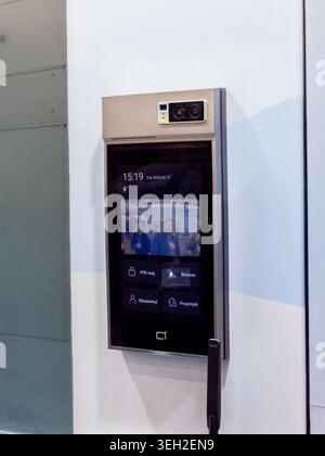 A wall-mounted digital intercom system featuring a high-definition touch screen, dual cameras for facial recognition, and a user-friendly Ukrainian in Stock Photo