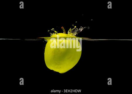 Dynamic Image Of Lime Halting Midair Splatter With Crown Droplets In Studio Setting Stock Photo